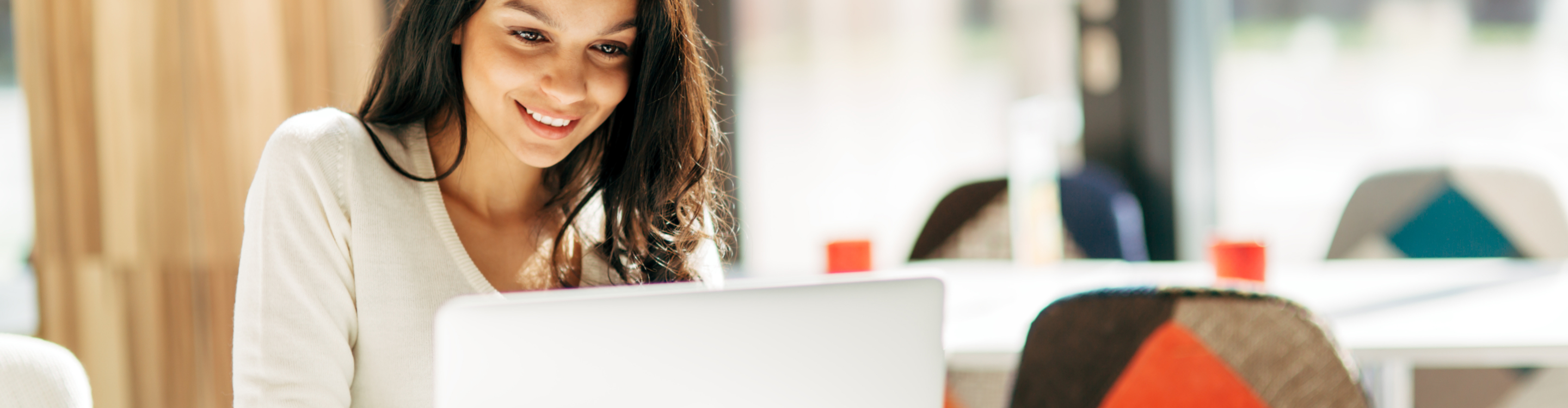 Woman shopping for flooring from home with a laptop